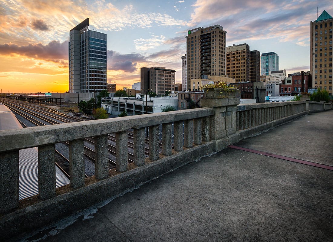 Contact - View of Buildings in Downtown Birmingham Alabama from a Concrete Bridge at Sunset