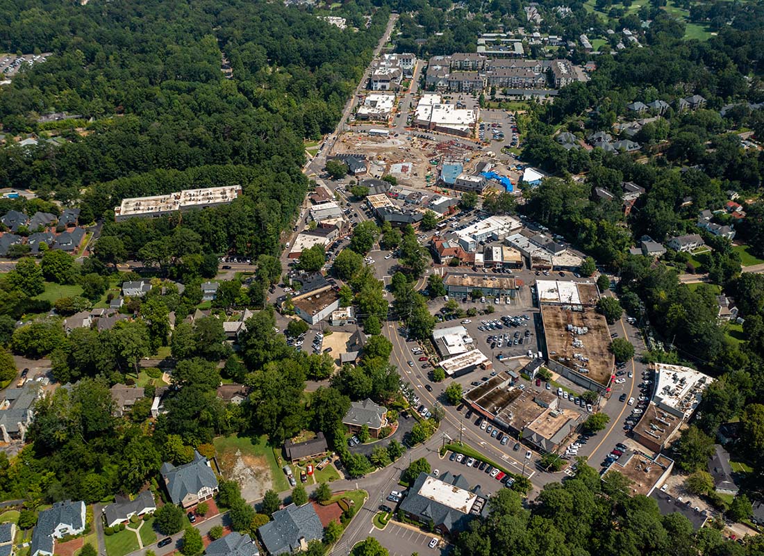 Hoover, AL - Aerial View of Buildings and Homes Surrounded by Green Trees in the Town of Hoover Alabama